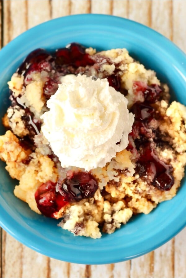 Blueberry dump cake in a blue bowl.