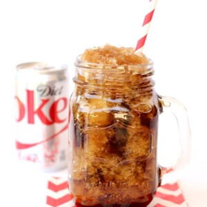 Diet Coke Slushie in a jar with a straw.