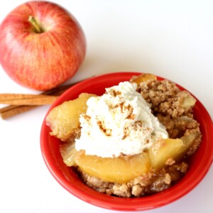 Baked apple dump cake with whipped cream on top.