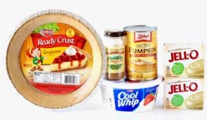 Ingredients to make a No-Bake Pumpkin Pie including Cool Whip, pumpkin, and pumpkin pie slice.