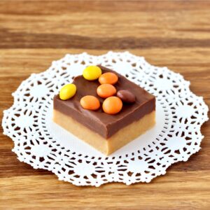 Piece of chocolate peanut butter Reese's Fudge on doily.