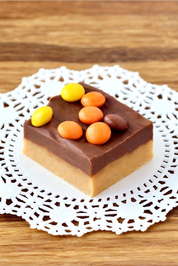 Piece of chocolate peanut butter Reese's Fudge on doily.