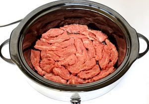 Beef strips in a slow cooker.
