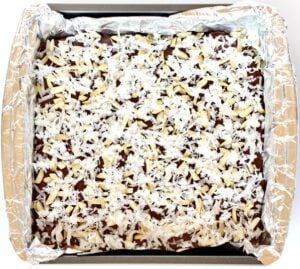 Almond Joy Fudge in a lined baking pan.