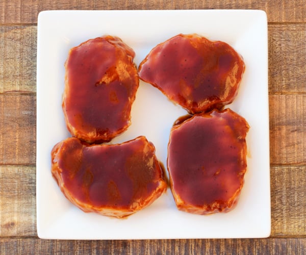 Cooked barbecue pork chops on plate.