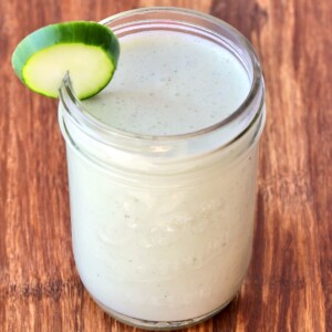 Tzatziki Sauce with a cucumber slice.