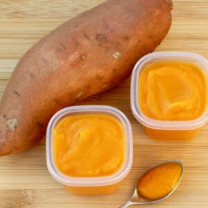 Sweet potato with containers of sweet potato baby food.