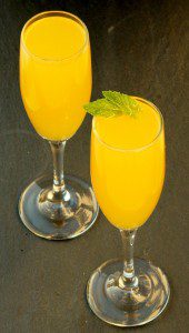 Two glasses of mango peach Bellini mocktail.