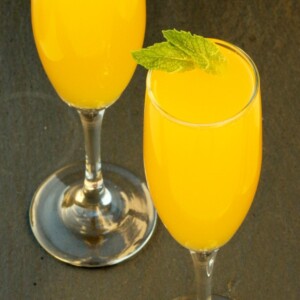Two glasses of mango peach Bellini mocktail.