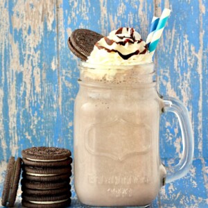 Oreo milkshake in a jar topped with whipped cream.