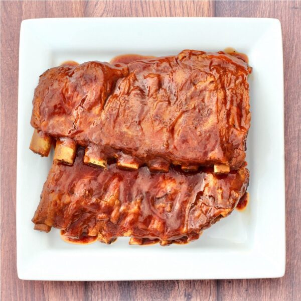 BBQ Ribs on a square, white plate.