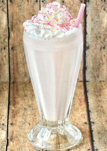 Strawberry Milkshake in a tall glass.