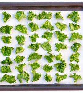 Lined baking sheet of Kale Chips.