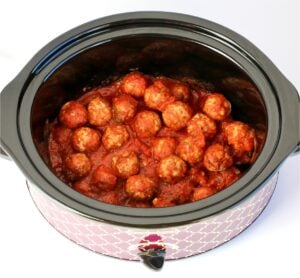 Cooked Italian Meatballs with sauce in crockpot.