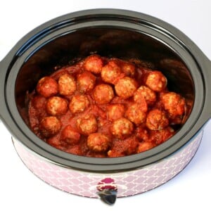 Cooked Italian Meatballs with sauce in crockpot.