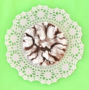 Chocolate Crinkle Cookie on a paper doily.