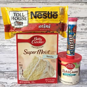 Chocolate chips, vanilla cake mix, vanilla frosting, and mini M&Ms.