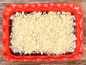 Crumble topping over raspberry filling.