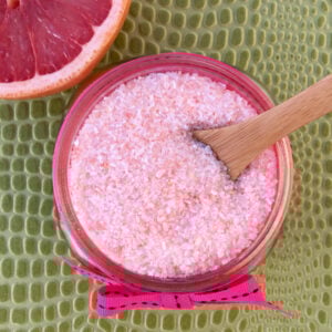 Spoon in a jar of Grapefruit bath salts.