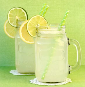 Lemon punch in mason jars with lemon and lime.