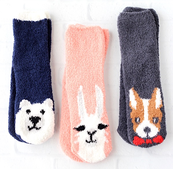 Three pairs of cozy fuzzy socks with animals on the front.