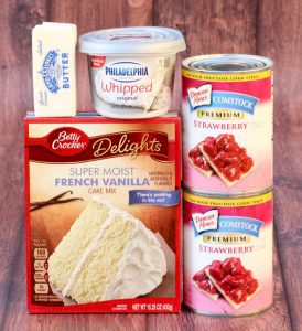 Cake ingredients including whipped cream cheese, butter, and strawberry filling.