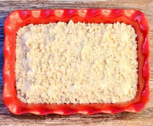 Strawberry Cream Cheese Dump Cake topped with crumble topping.