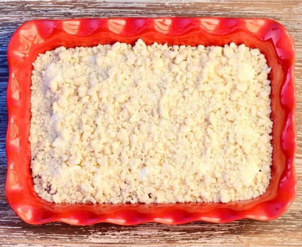 Strawberry Cream Cheese Dump Cake topped with crumble topping.
