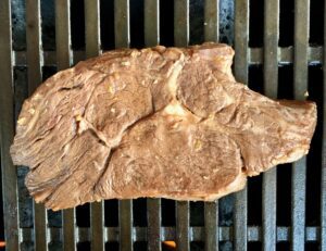 Marinated steak on a grill.