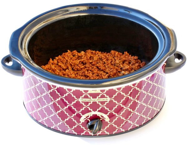 Seasoned and cooked beef taco meat in slow cooker.