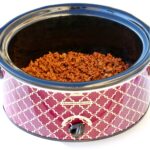 Cooked and seasoned beef taco meat in slow cooker.