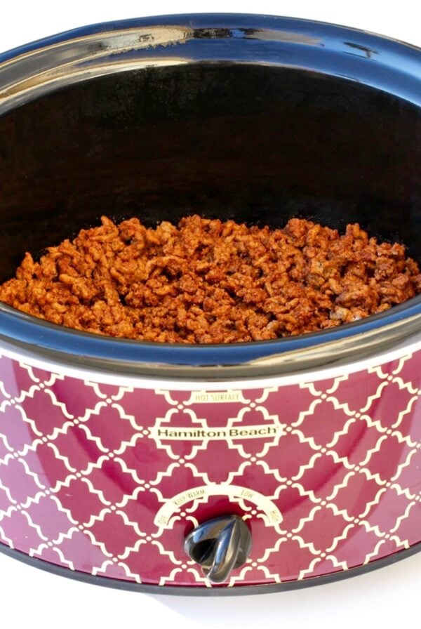 Cooked and seasoned beef taco meat in slow cooker.