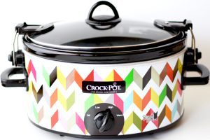 Lid on a colorful Crock Pot.