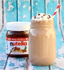 Nutella milkshake in mason jar with whip cream and chocolate shavings on top.
