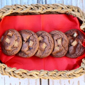 Chocolate Kit Kat cookies lined up on a napkin in a basket.