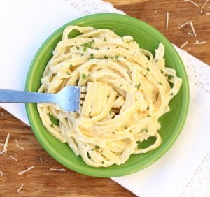 Green bowl of fettuccine alfredo.