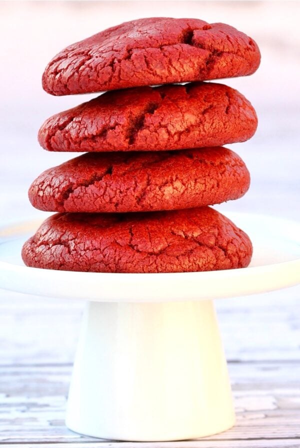 Stack of four red velvet cake mix cookies on cookie stand.