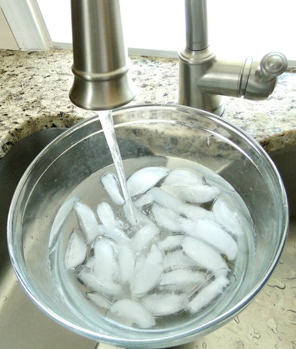 Ice water in bowl for hard boiled egg ice bath.