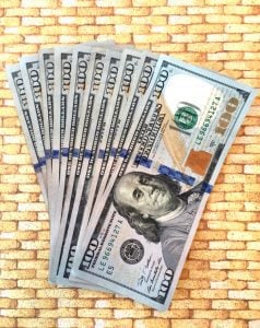 Stack of several $100 bills.