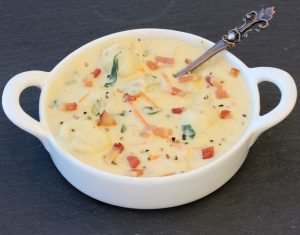 Gnocchi soup in a white bowl.