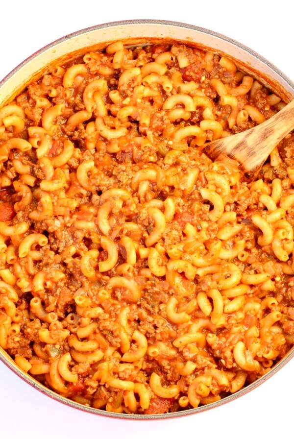 American goulash in Dutch oven with wooden spoon.