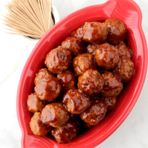 Meatballs in a red oblong dish.