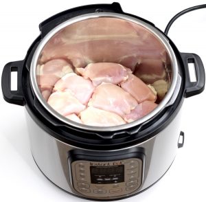 Raw chicken thighs in an Instant Pot.