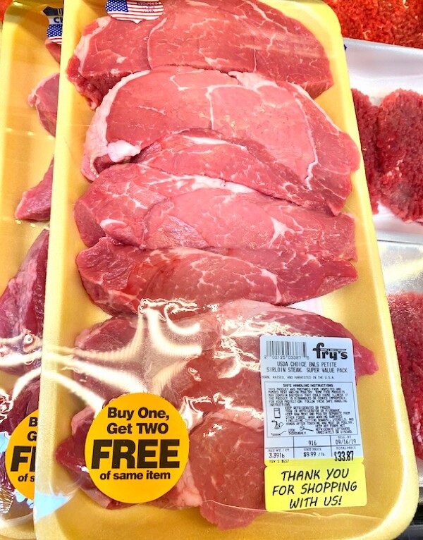 Yellow packages of sirloin steak.