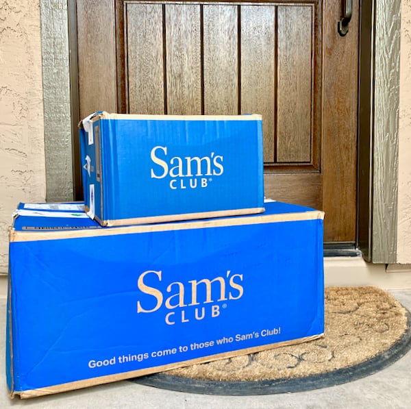 Sam\'s Club boxes in front of house door.