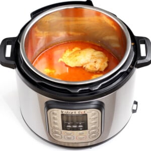 Buffalo chicken with sauce in an Instant Pot.