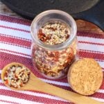 Steak Seasoning in small jar and on a spoon.