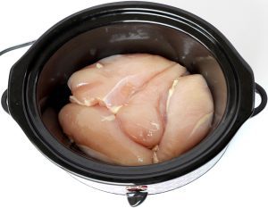 Chicken breasts in a slow cooker.