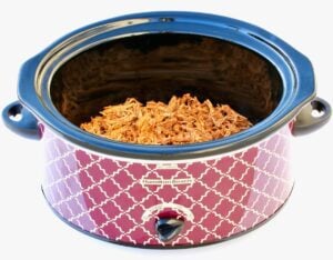 Chicken taco meat in a slow cooker.