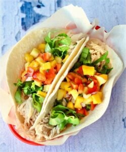 Two chicken tacos in a basket.